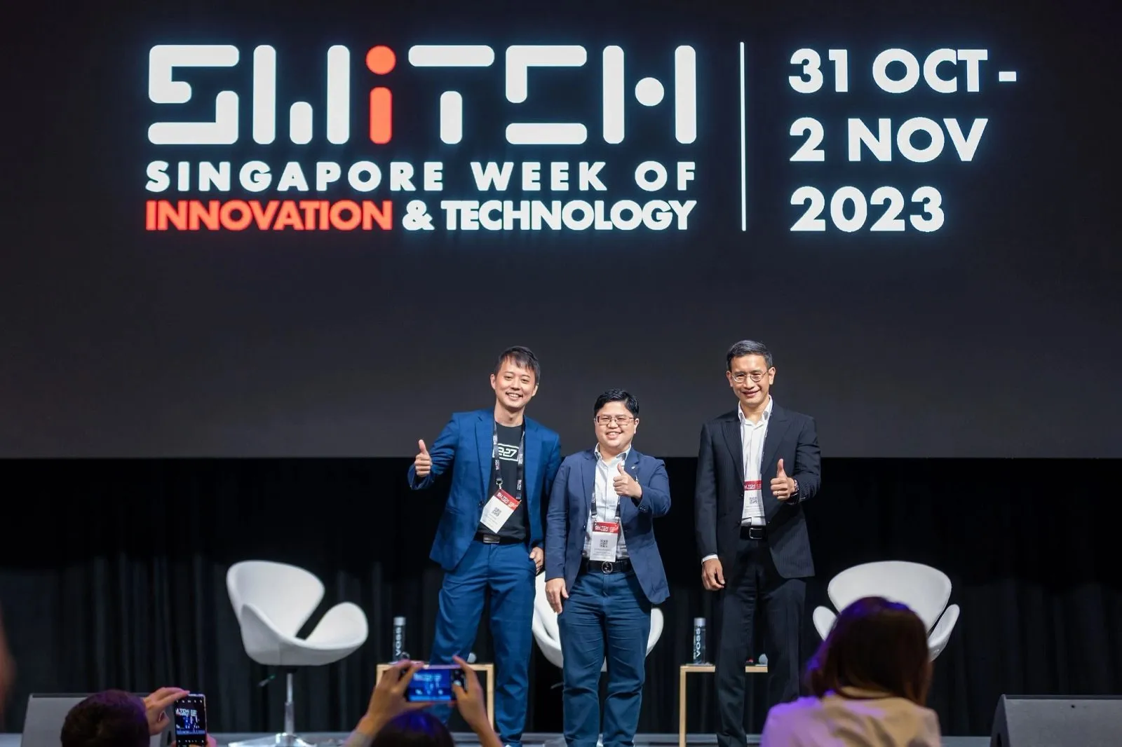 Speakers posing on stage after a session at a Singapore innovation conference — RS Photography