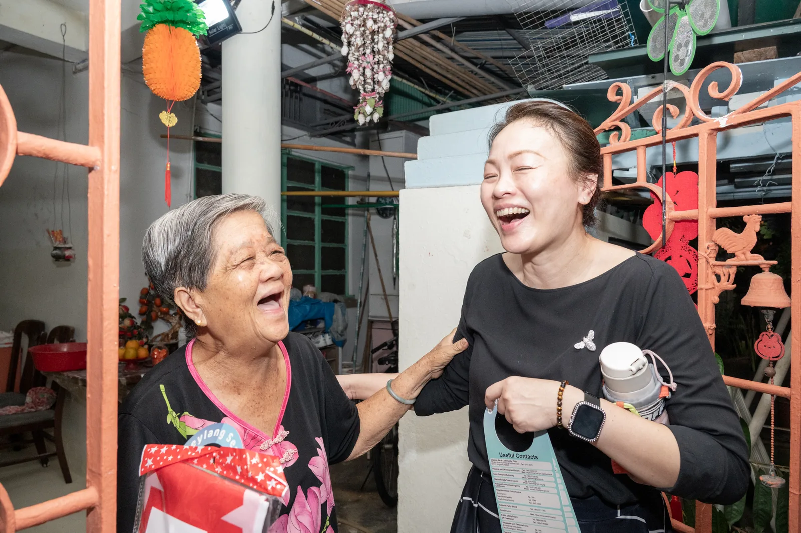 Candid moment between guests at a community event in Singapore