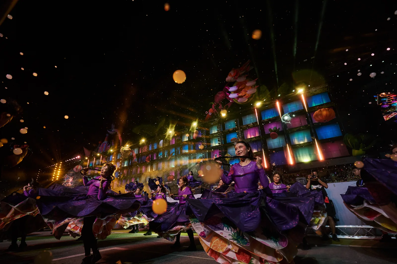 Dancers performing under coloured stage lighting at an evening corporate show