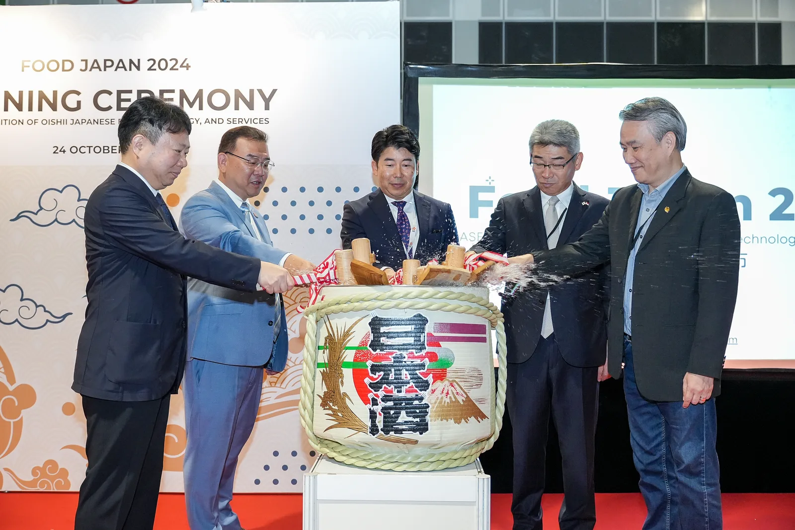 Dignitaries breaking open a sake barrel in a kagami-biraki opening ceremony at a Singapore trade expo