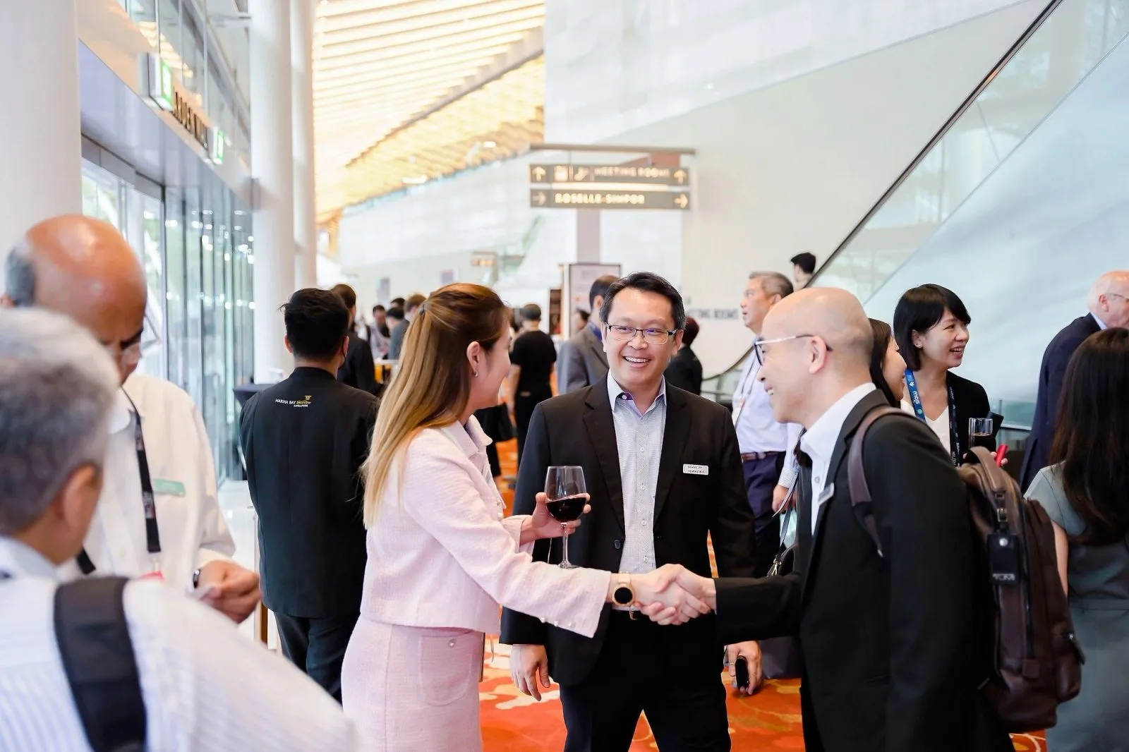 Delegates networking in the lobby of a Singapore convention venue — RS Photography