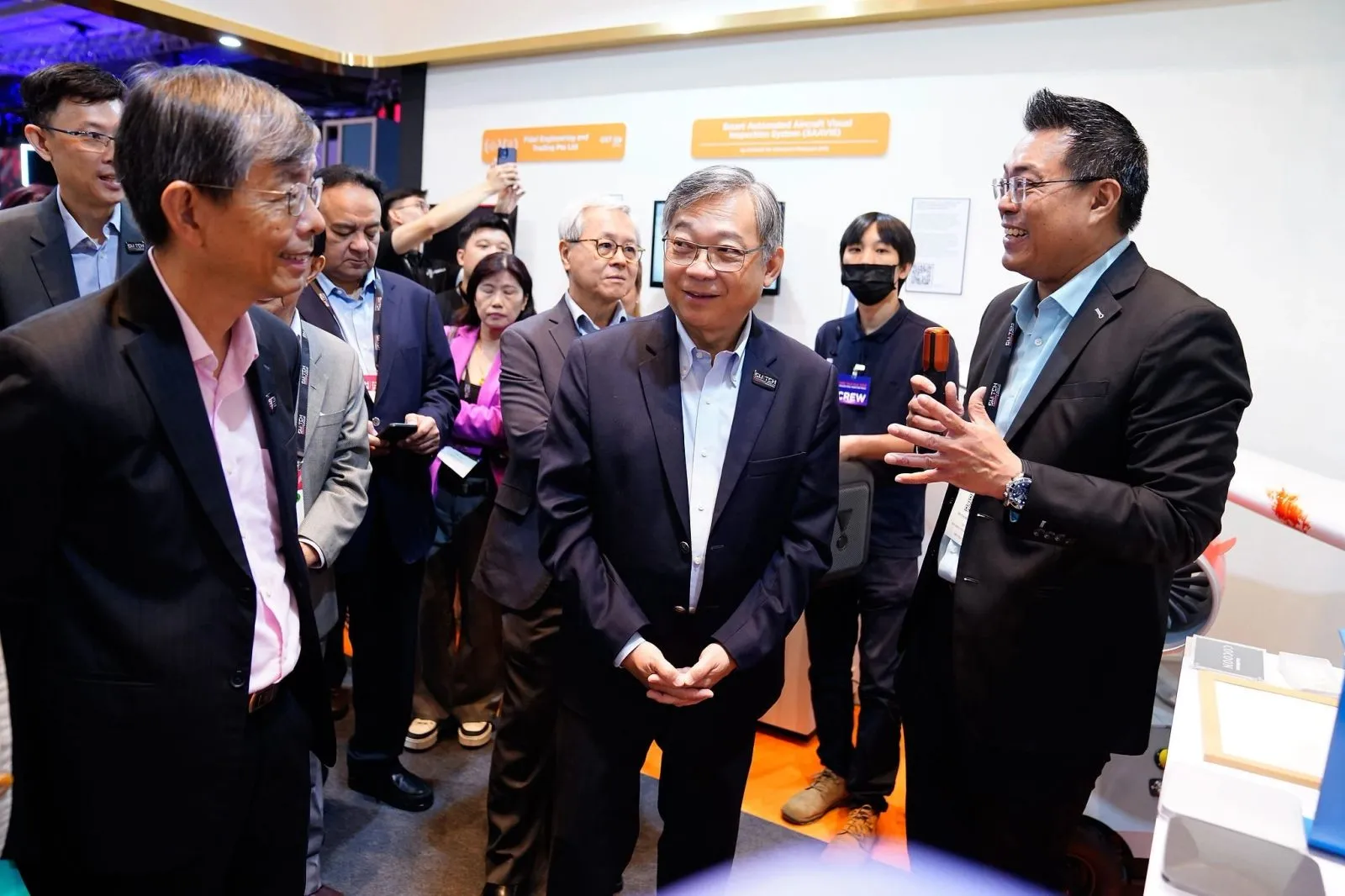 Ministerial delegation being guided through an exhibition showcase — RS Photography