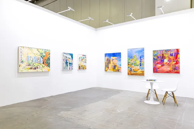 Gallery wall of paintings at an art exhibition