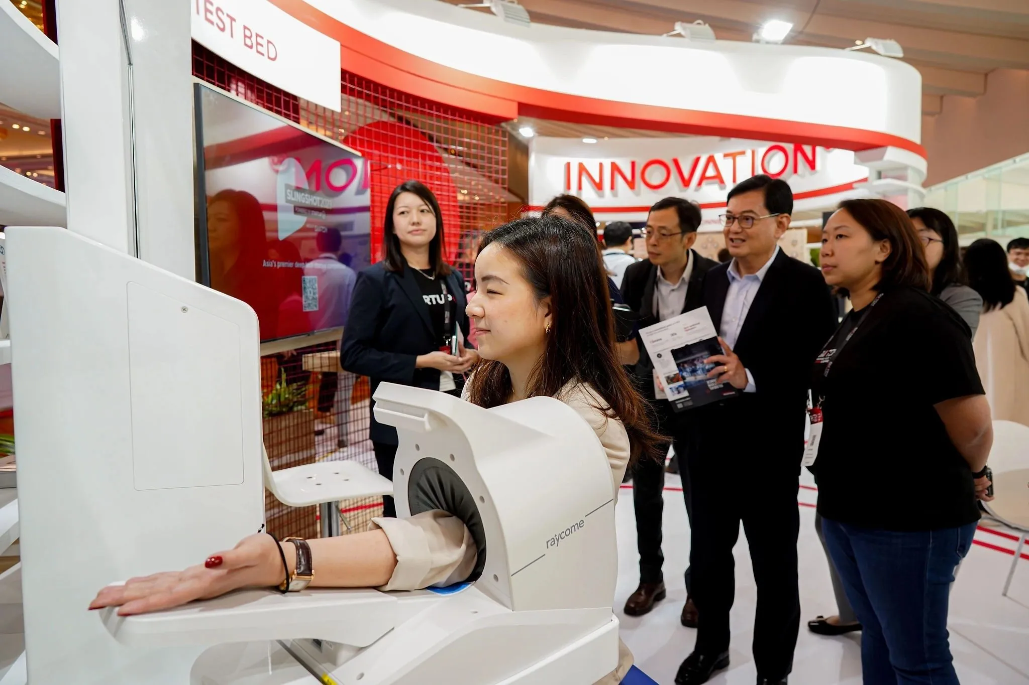VIP delegation touring an innovation showcase booth at a Singapore trade exhibition — RS Photography