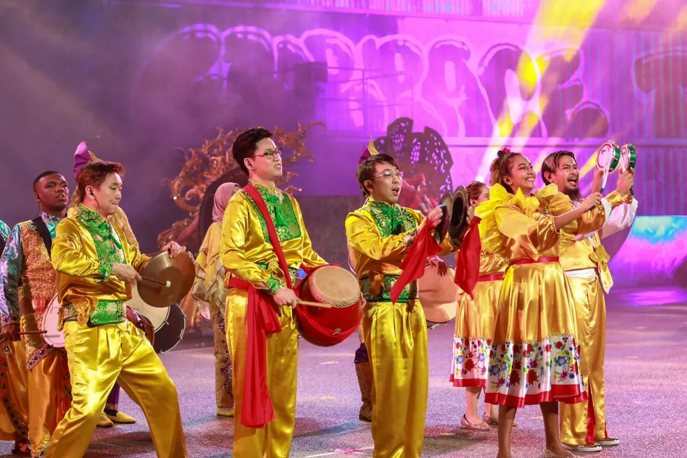 Drummers in gold costumes performing at a cultural celebration