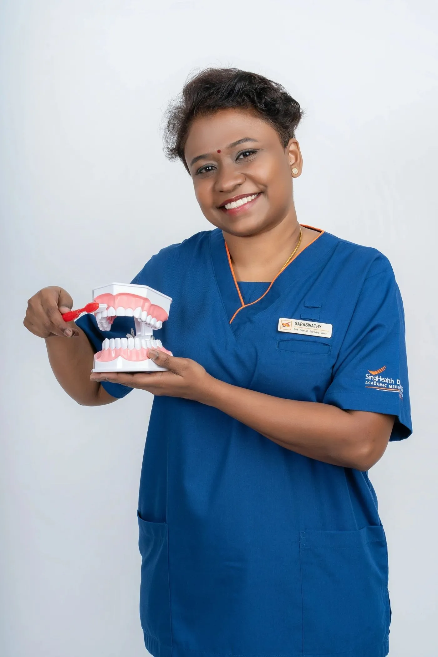 Creative portrait of a dental professional with a prop