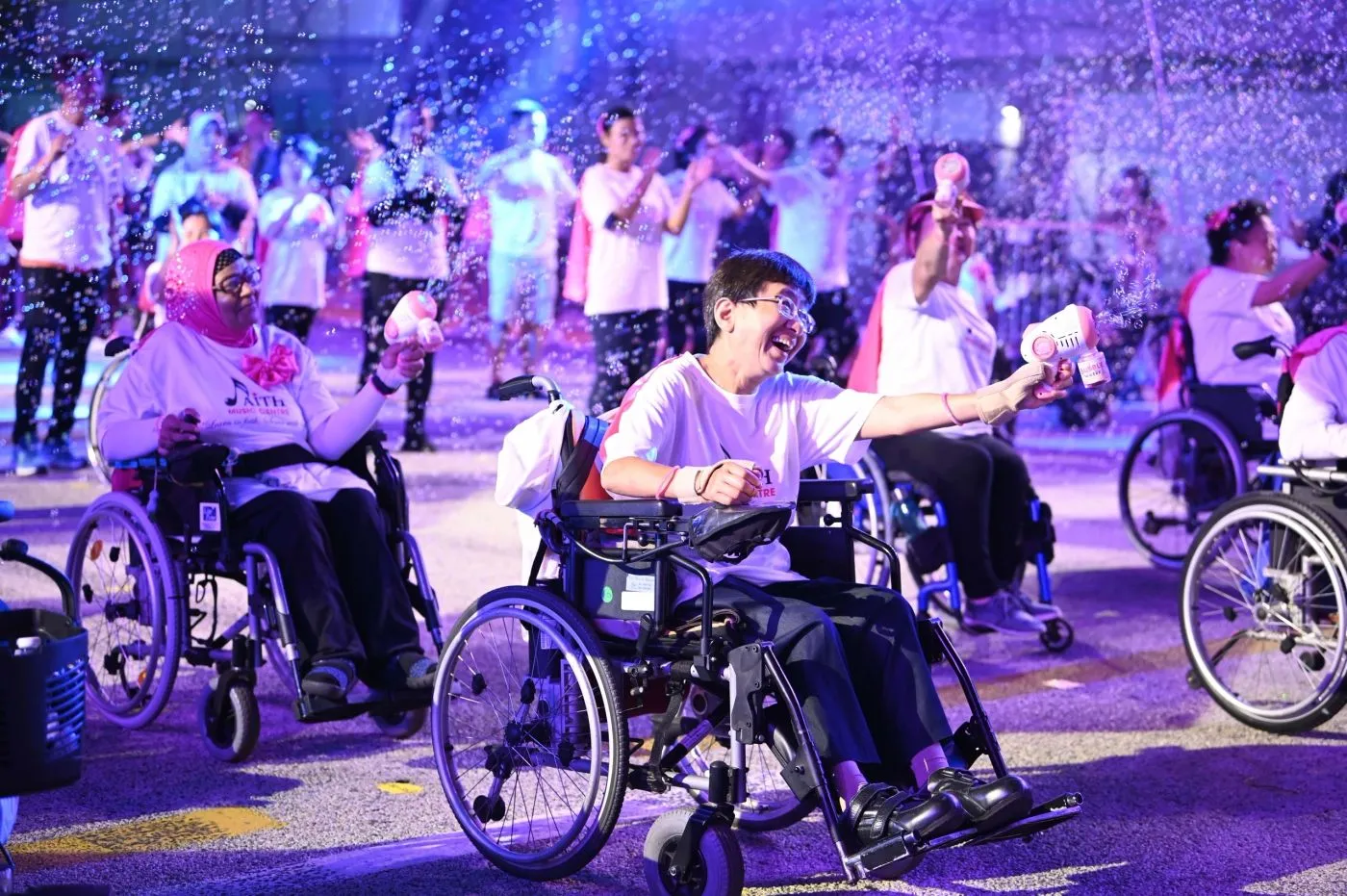 Wheelchair performers celebrating in confetti at a national parade